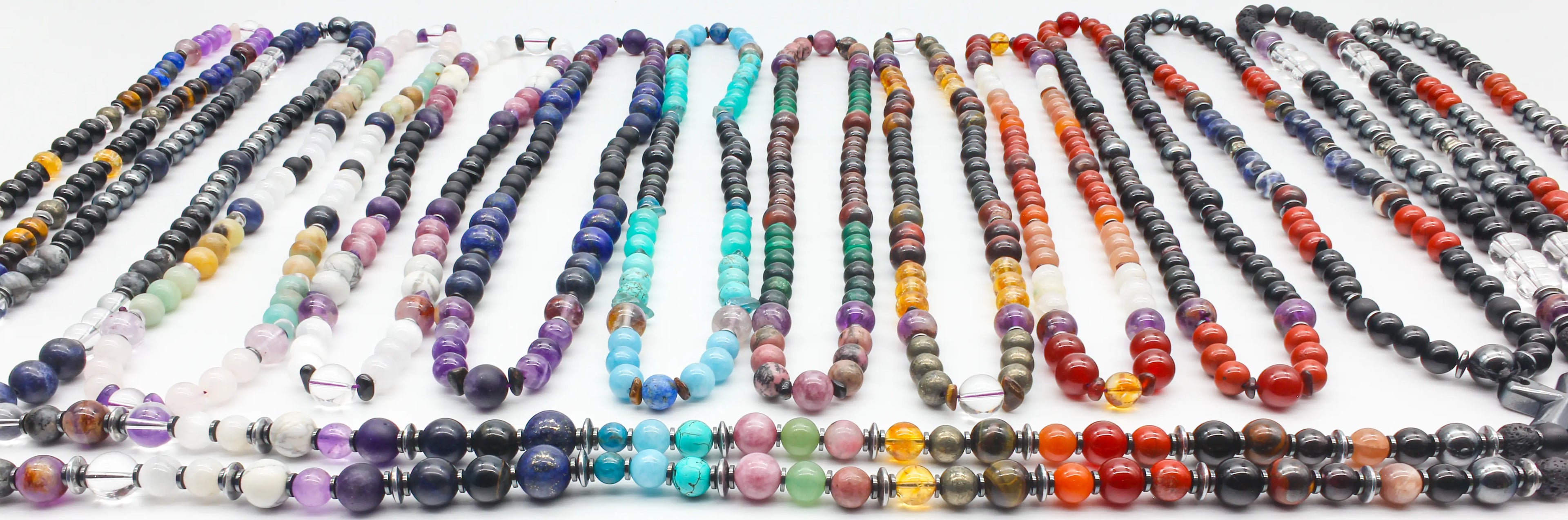 Lightseed gemstone or crystal necklaces, each featuring embedded crystals (like quartz or amethyst) and metallic hematite rings, The pendants hang from adjustable black cords or chains, blending spiritual energy tools with minimalist jewelry design.
