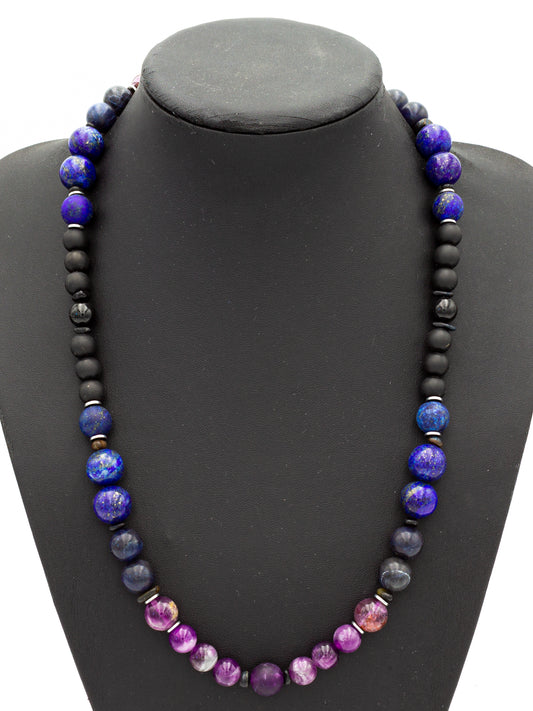 A handcrafted beaded necklace featuring deep indigo and violet stones, designed to enhance the connection to higher consciousness. Rich hues of lapis lazuli, sodalite, amethyst, and charoite blend seamlessly with grounding black onyx and hematite, forming a balanced energetic flow. The beads radiate a celestial glow, activating the third eye and crown chakras for spiritual insight, wisdom, and inner clarity.